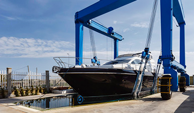 boatyard crane lifting a marine vessel